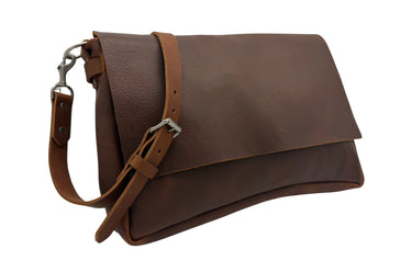 A dark brown leather shoulder bag with a wide front flap, a coordinating adjustable leather strap, and silver-tone metal hardware, shown on a plain white background.
