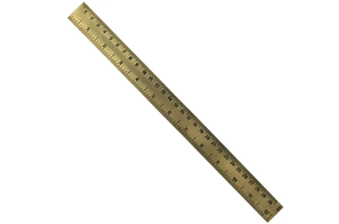 A brass ruler with black engraved measurements, shown diagonally on a plain white background.