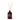 A reed diffuser with amber glass bottle and liquid, multiple light brown reeds inserted, label on front with product information.